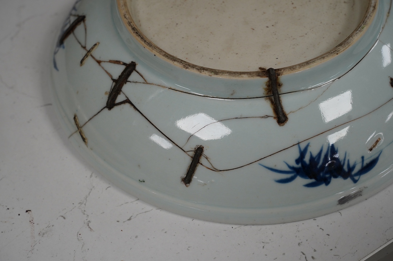 A Chinese underglaze blue and red and green enamelled 'horses' dish, Yongzheng period, 28.5cm. Condition - poor